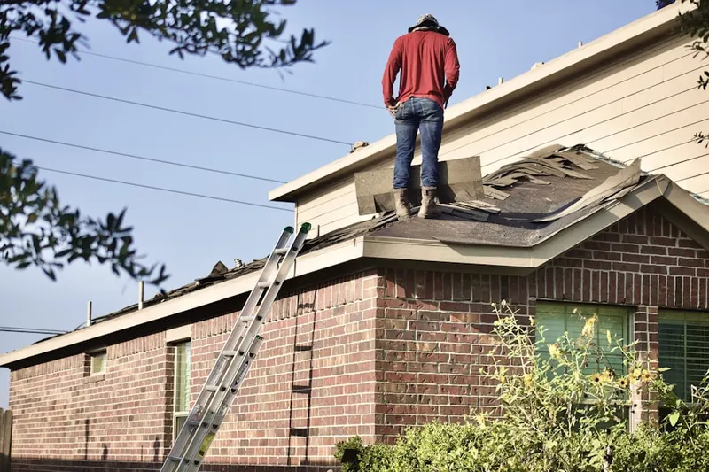Professional roofer working on a residential roof in Upper Makefield